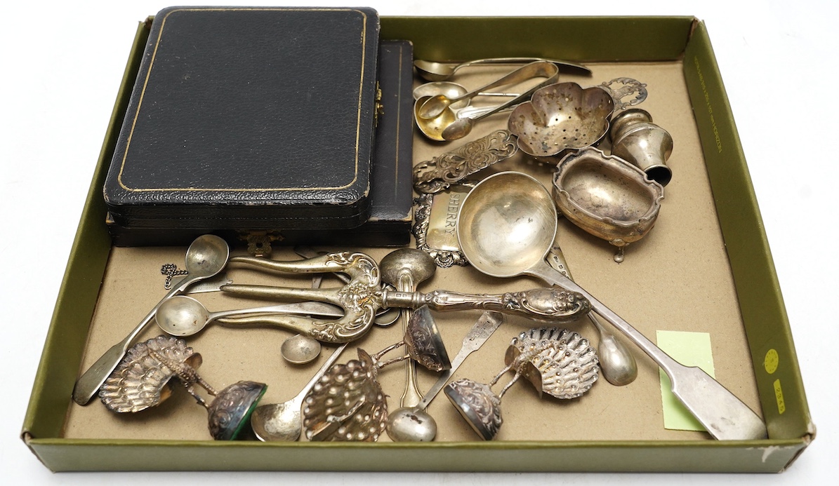 Sundry small silver including cased sets and loose flatware, condiments, a white metal tea strainer and peacock menu holders, etc. Condition - poor to fair